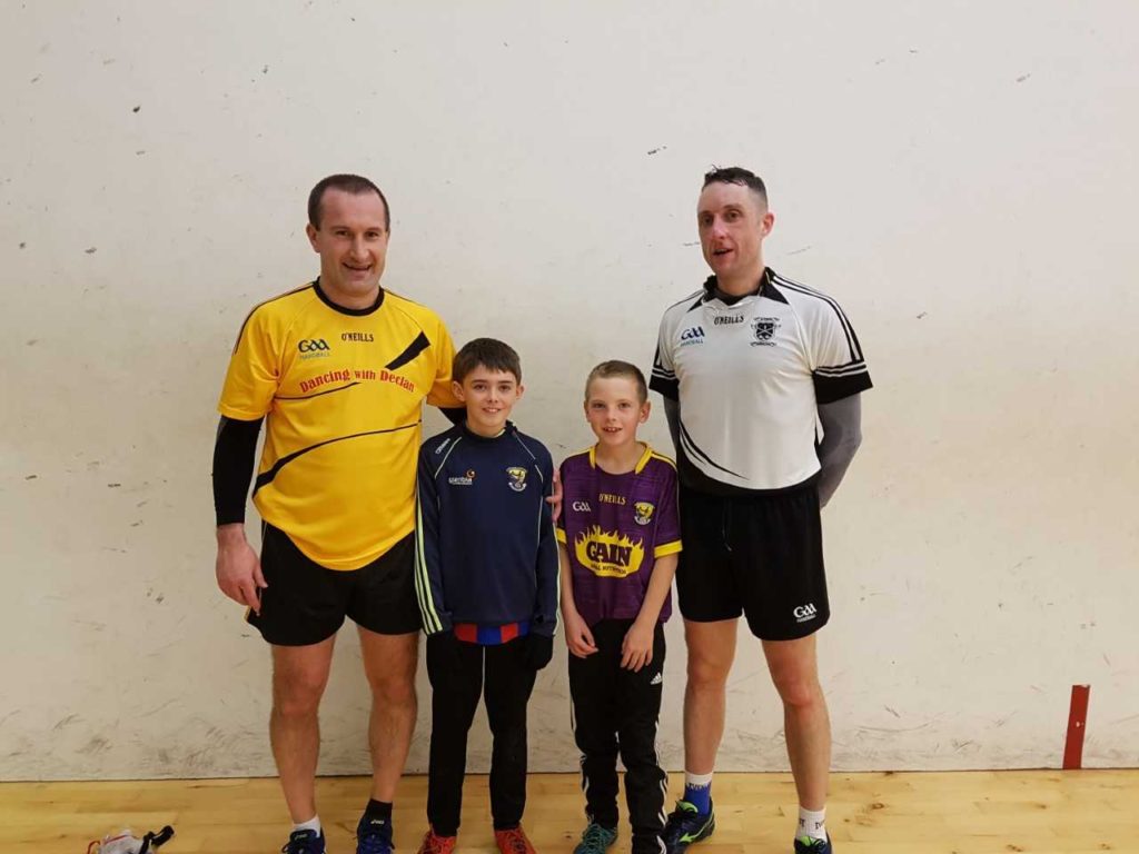 Budding young handballers Sean Fitzharris and Jamie Moran get to meet top players Barry Goff and Gavin Buggy ahead of last night's county senior singles group match.